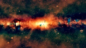 Image of the galactic center glowing red in artificially colored radio wavelengths of light. Red and blue splotches indicate other objects and phenomena emitting radio light.