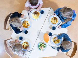 Des enfants déjeunent dans une cantine