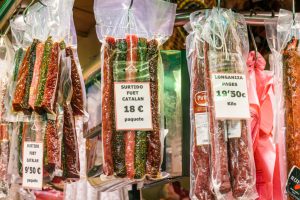 Spain, Barcelona, Mercat de la Boqueria, public market, sausage vendor display