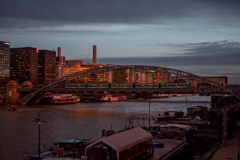 A picturesque view of a bridge over the Seine in Paris during evening twilight.