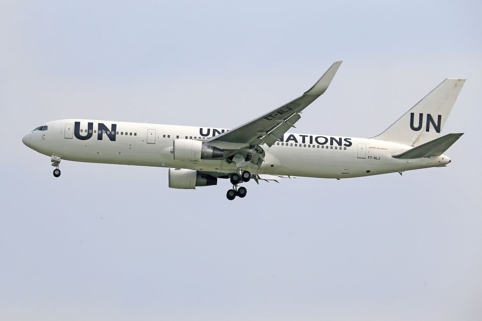 Side view of a UN Boeing aircraft in flight, showcasing aviation technology.