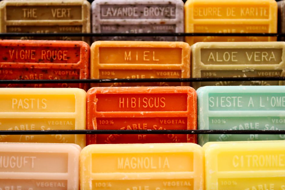 Colorful display of handmade aromatherapy soaps in various scents.