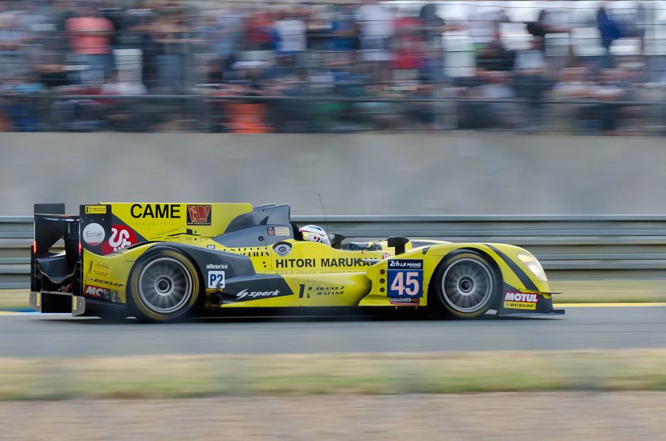 Dynamic shot of a race car at the Le Mans circuit in France, showcasing speed and precision.