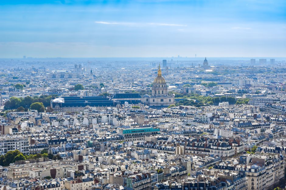 A breathtaking aerial shot of Paris featuring iconic landmarks under a vibrant sky.