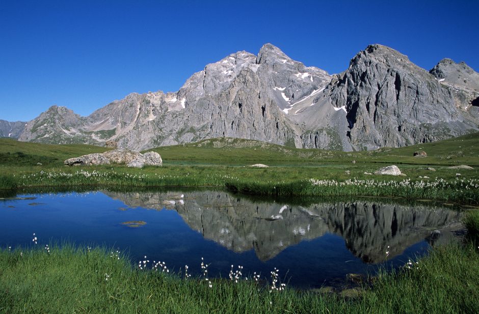 Beautiful mountain vistas reflected in a serene lake in the French Alps. Ideal for nature lovers.