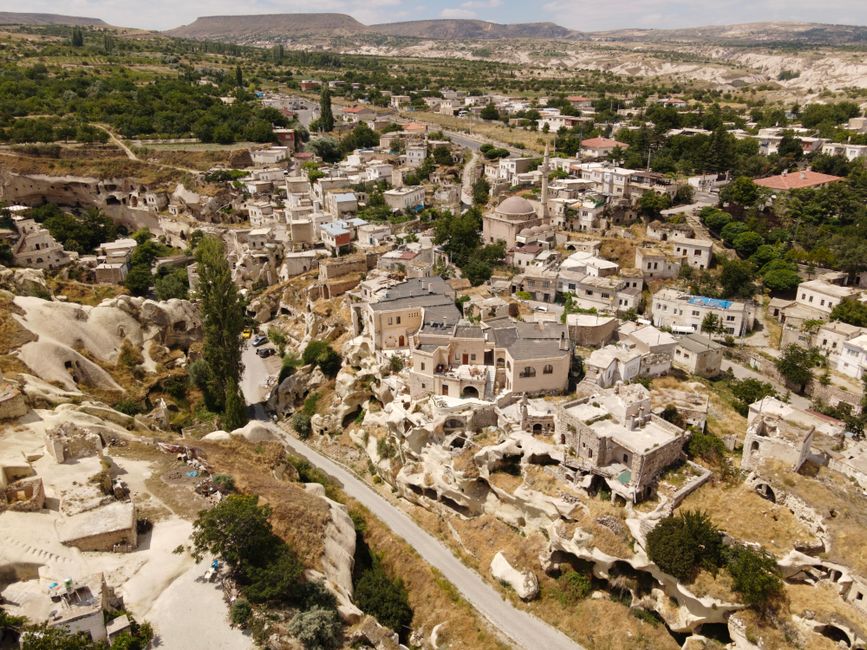 A stunning aerial shot of a unique Cappadocia village featuring rock formations and historic dwellings.
