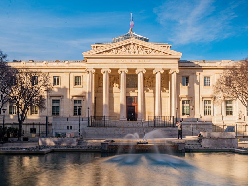 Palais de Justice reflecting neoclassical architecture with fountain in Marseille.