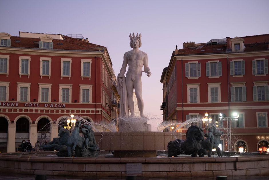 Explore the stunning Fontaine du Soleil in Nice, France, captured at twilight in Place Masséna.