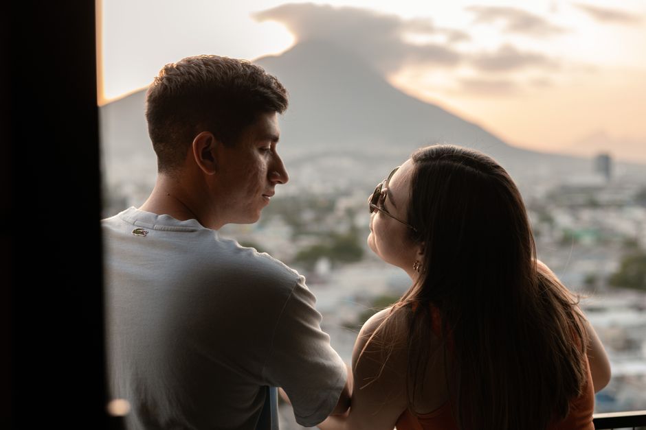 A couple enjoying a sunset with a scenic mountain view in Monterrey, Mexico.