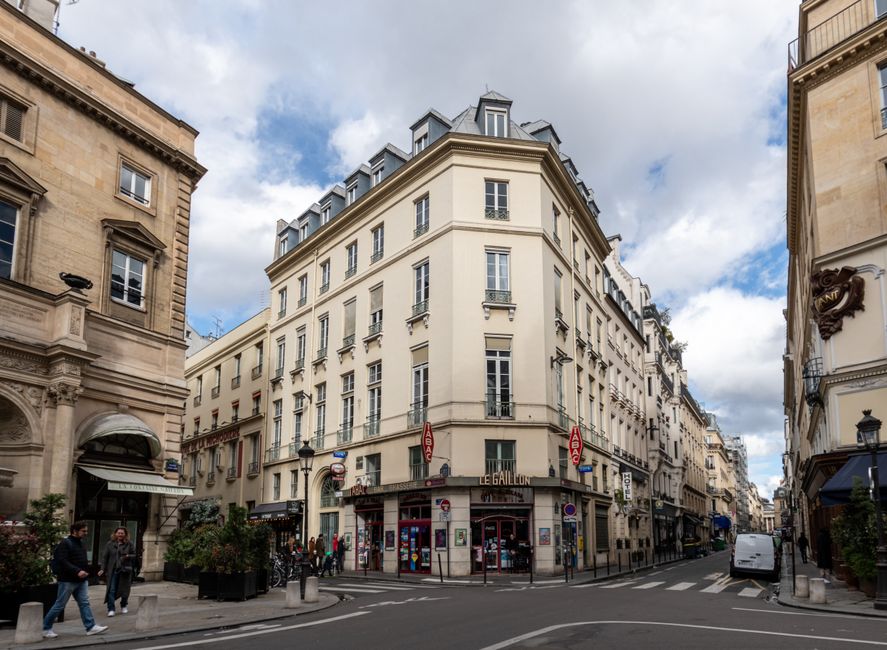 Charming street view of historic buildings in Paris, showcasing classic urban architecture.
