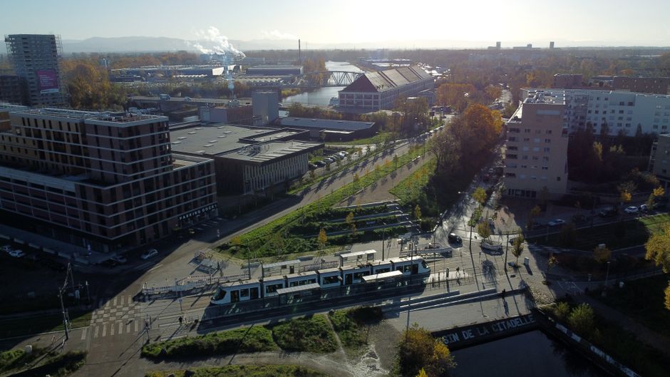Explore Strasbourg's urban landscape with a tram and river view from above in autumn.