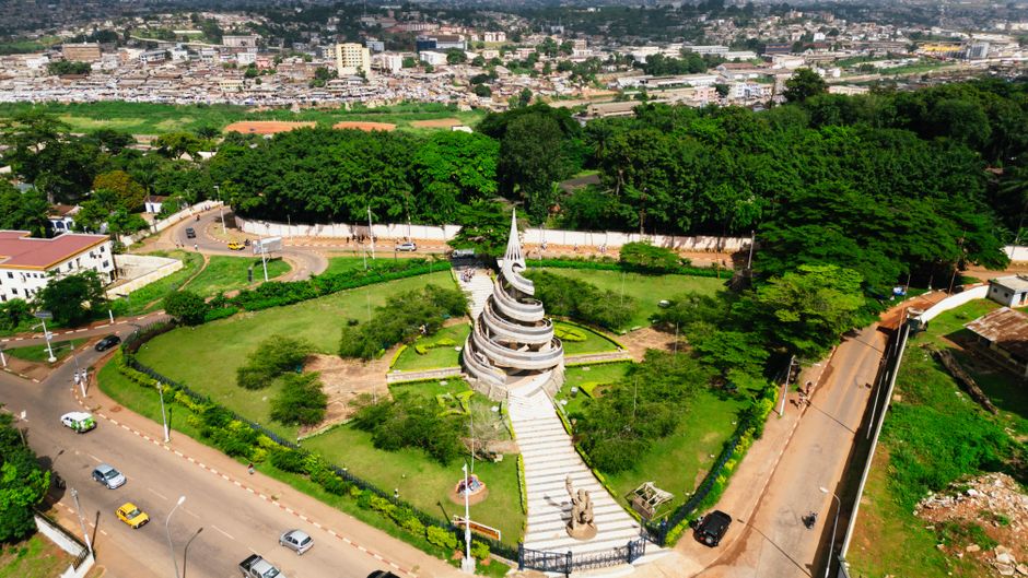 A stunning aerial shot of the Reunification Monument surrounded by greenery in Yaoundé, Cameroon.