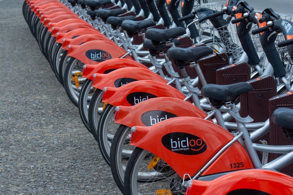 Close-up view of bicloo rental bicycles lined up in Nantes, France, awaiting use.