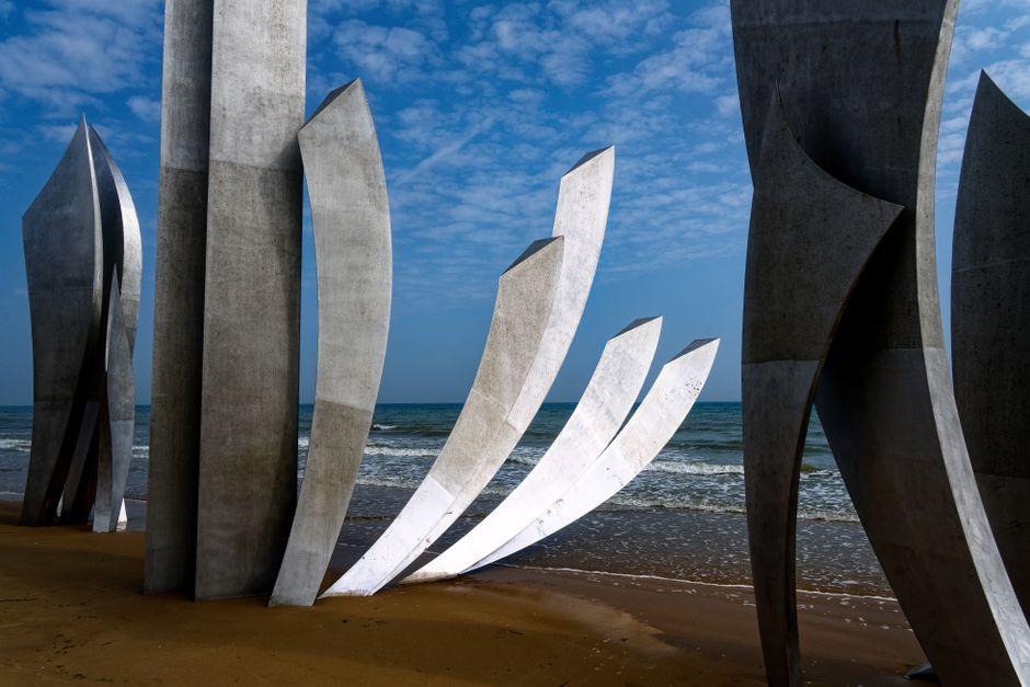 Stunning view of the Omaha Beach Memorial sculptures at Saint-Laurent-sur-Mer with the sea and sky as a backdrop.