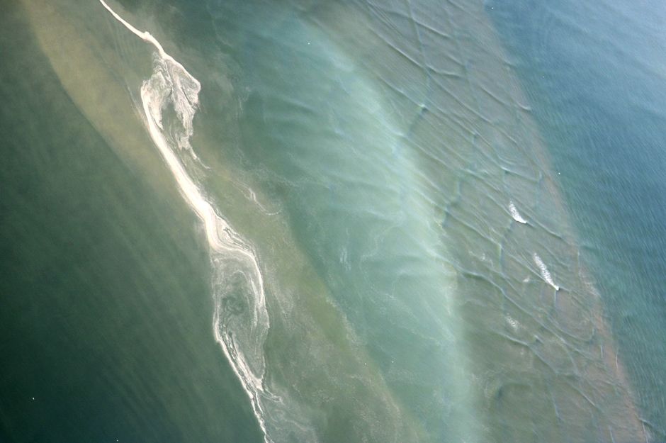 Aerial shot of water patterns near Le Mont-Saint-Michel, France, showcasing natural textures.