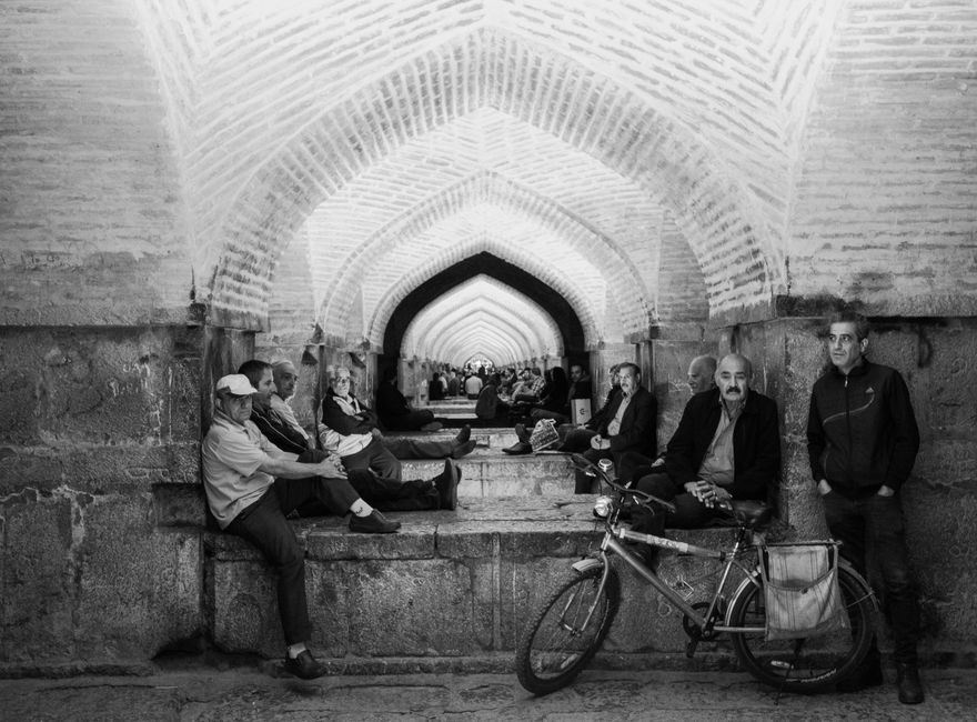 Capturing a moment of leisure under the traditional arches of Isfahan.
