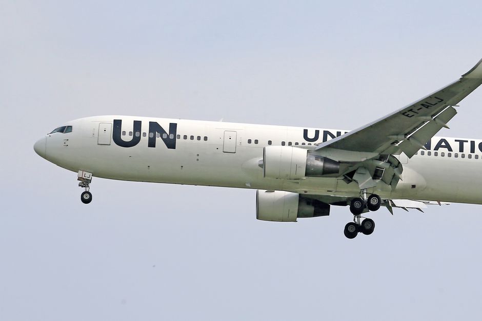 Close-up of a United Nations airplane in flight, showing detailed landing gear.