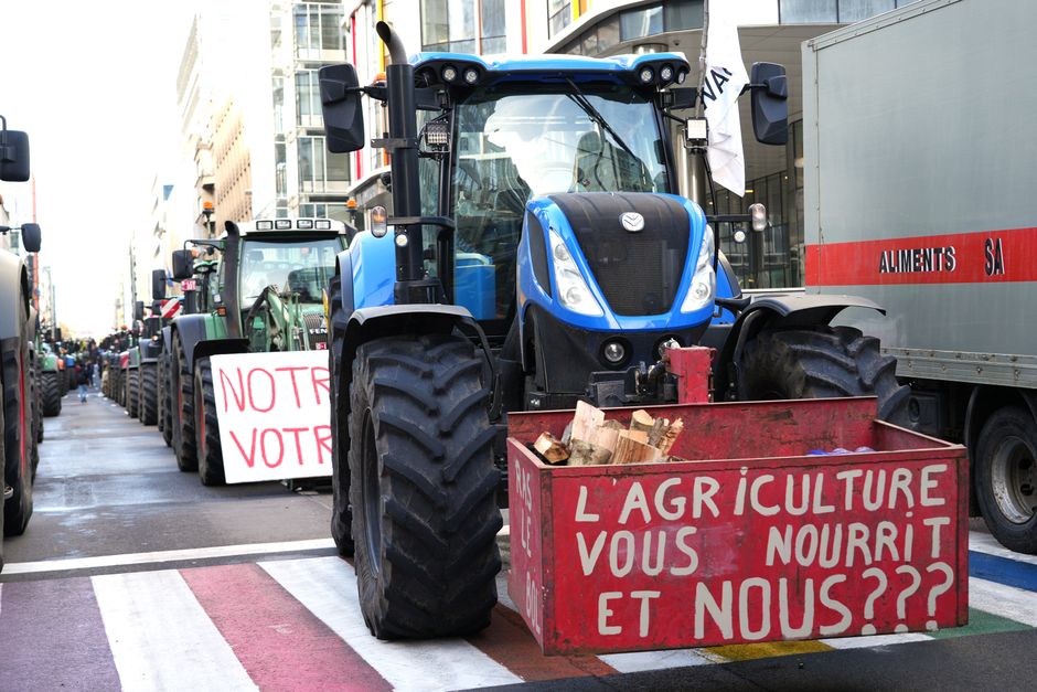 Tractors line a city street in a protest advocating for agricultural issues.