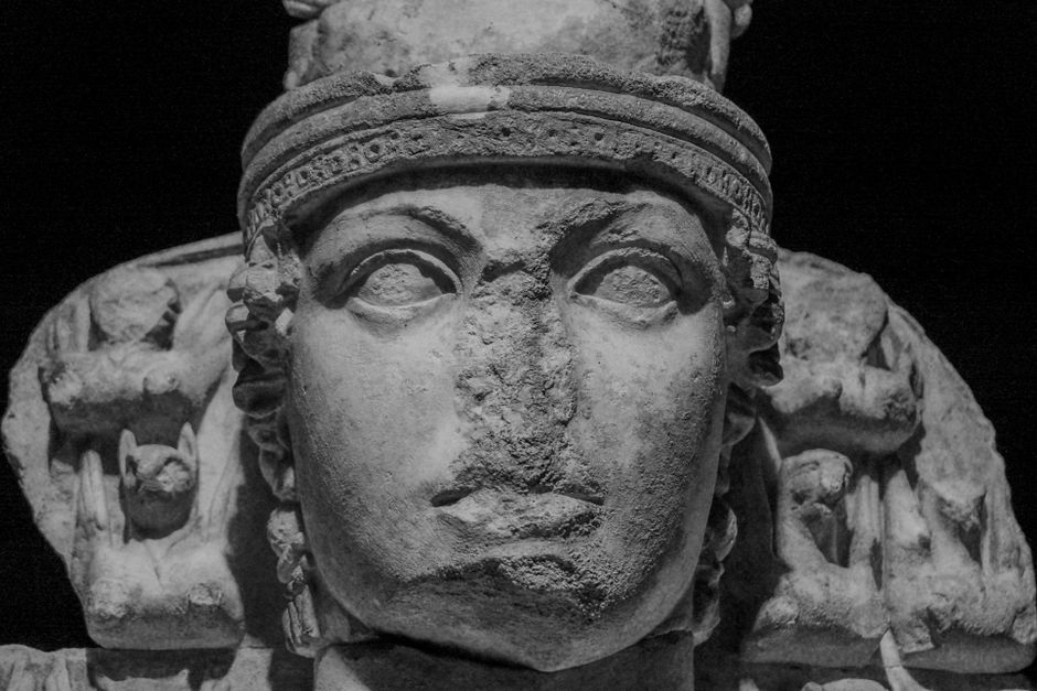 Close-up of an ancient Greek goddess sculpture, highlighting detailed carving.