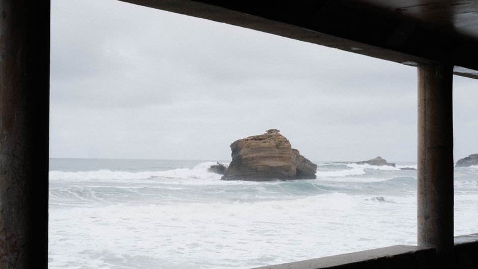 Breathtaking ocean view from Biarritz, France, capturing waves crashing against the Rocher de la Vierge.