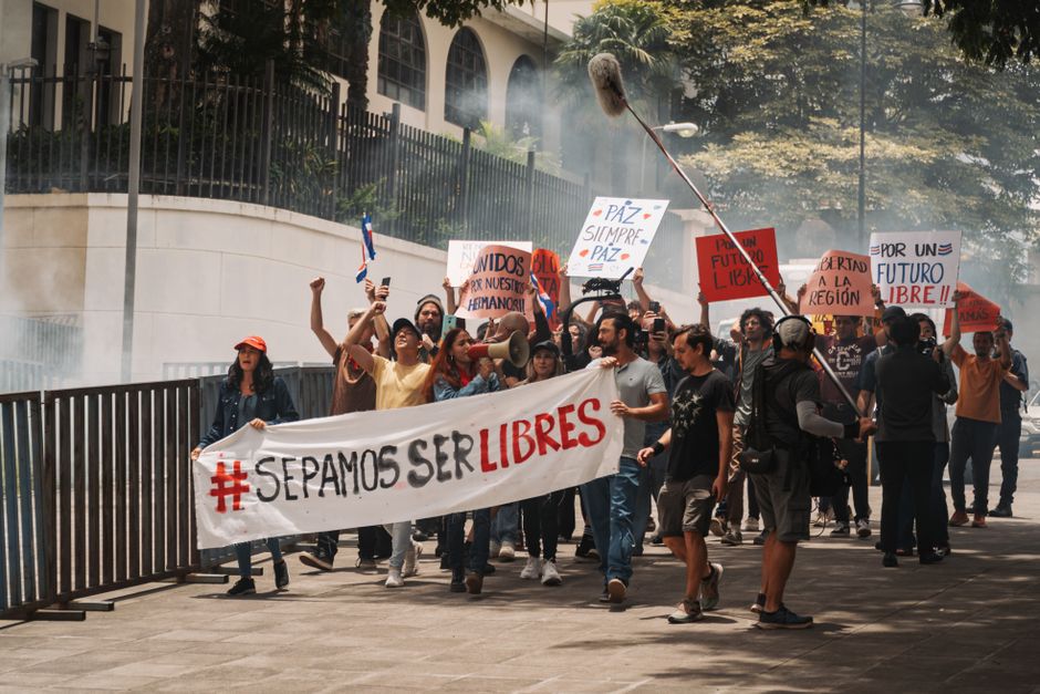 Demonstrators holding banners and signs during a peaceful protest in San José, Costa Rica.