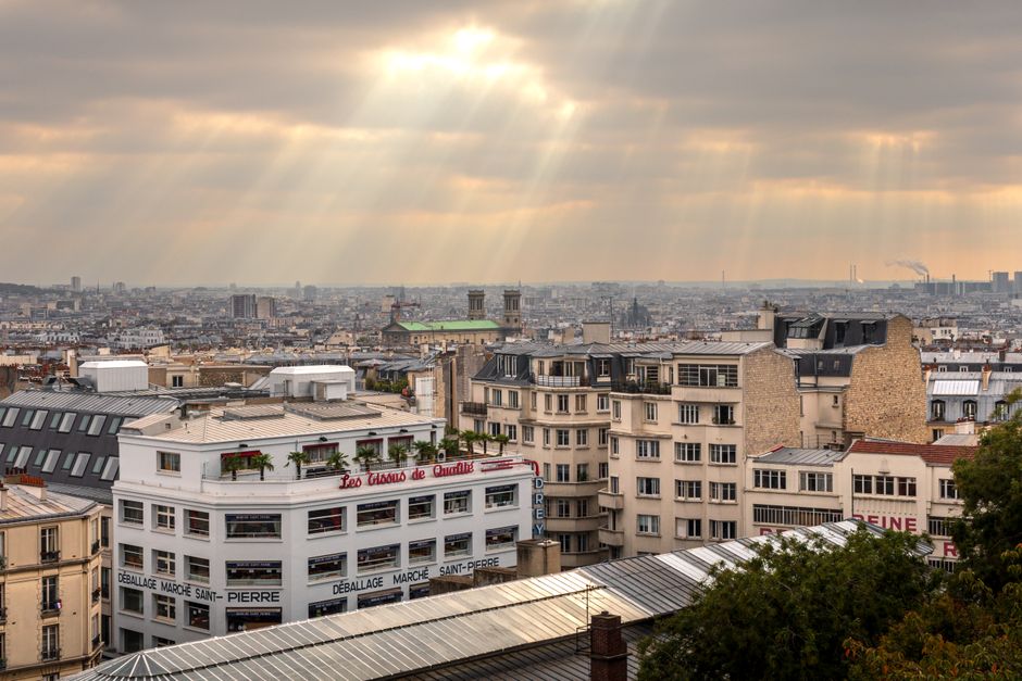 Beautiful urban cityscape of Paris under sunlit skies, showcasing iconic architecture.