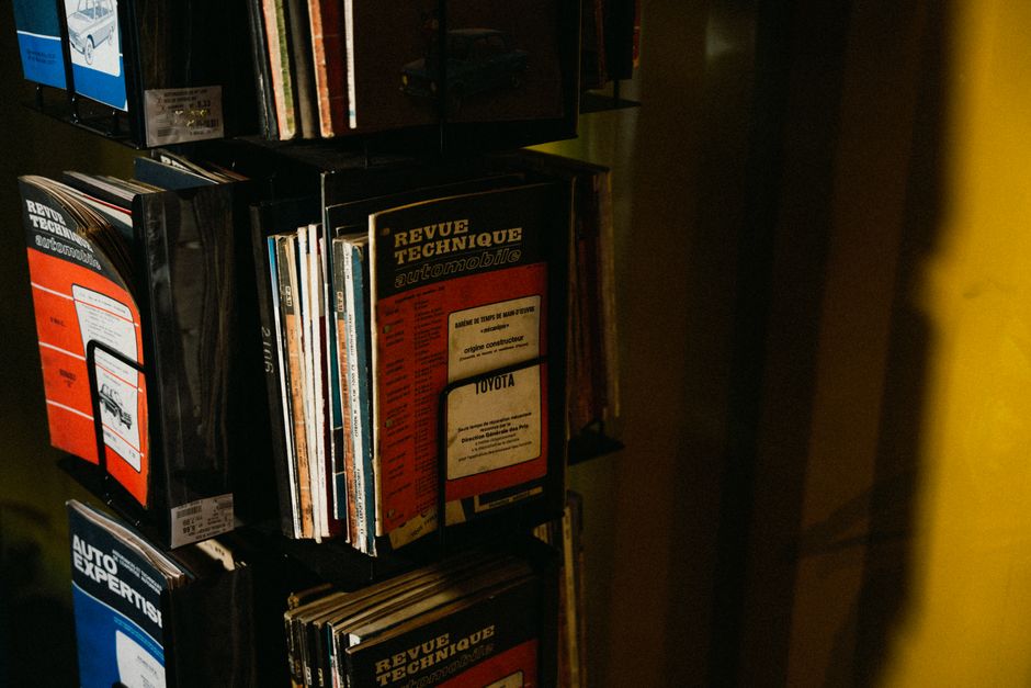 A collection of vintage car repair manuals on display, showcasing automotive history.