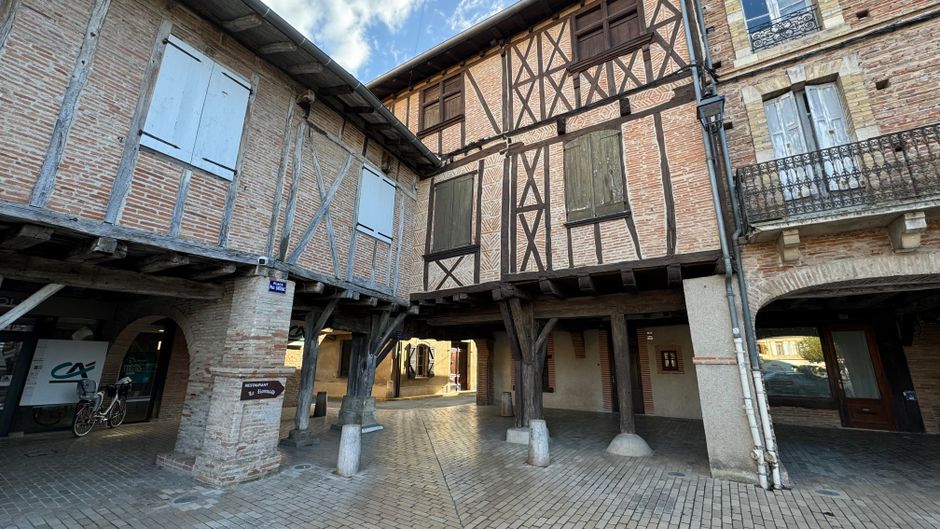 Charming view of medieval timber-framed buildings in a quaint French town.