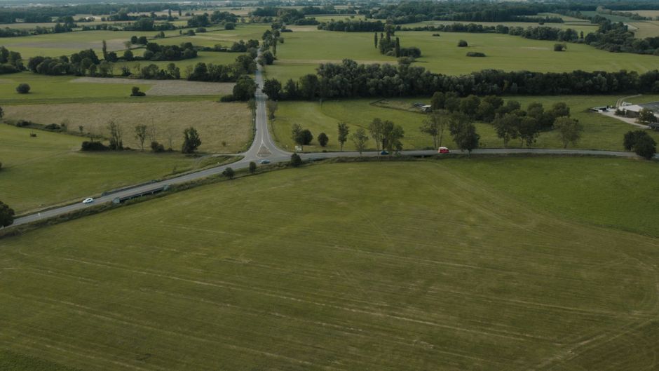 Serene aerial view of green fields and roads in Muttersholtz, France countryside.