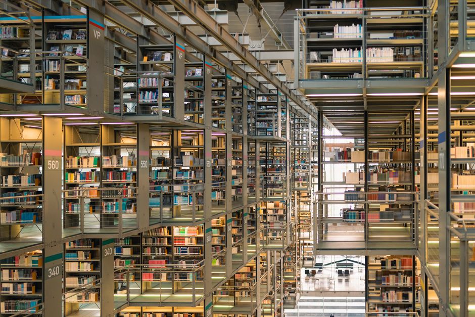 Rows of bookshelves in a modern library in Mexico City, showcasing a vast collection of books.