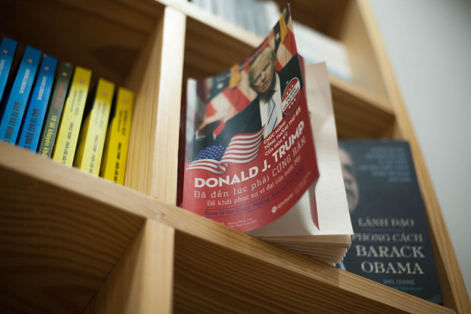 A close-up view of a bookshelf with books featuring political leaders in a bookstore setting.