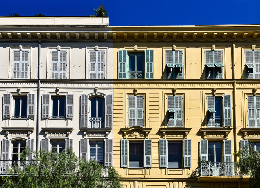 Vibrant building facade in the sunlit streets of Southern France's Provence region.