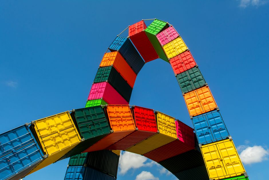 Colorful shipping container sculpture against blue sky, symbolizing modern art in Le Havre.