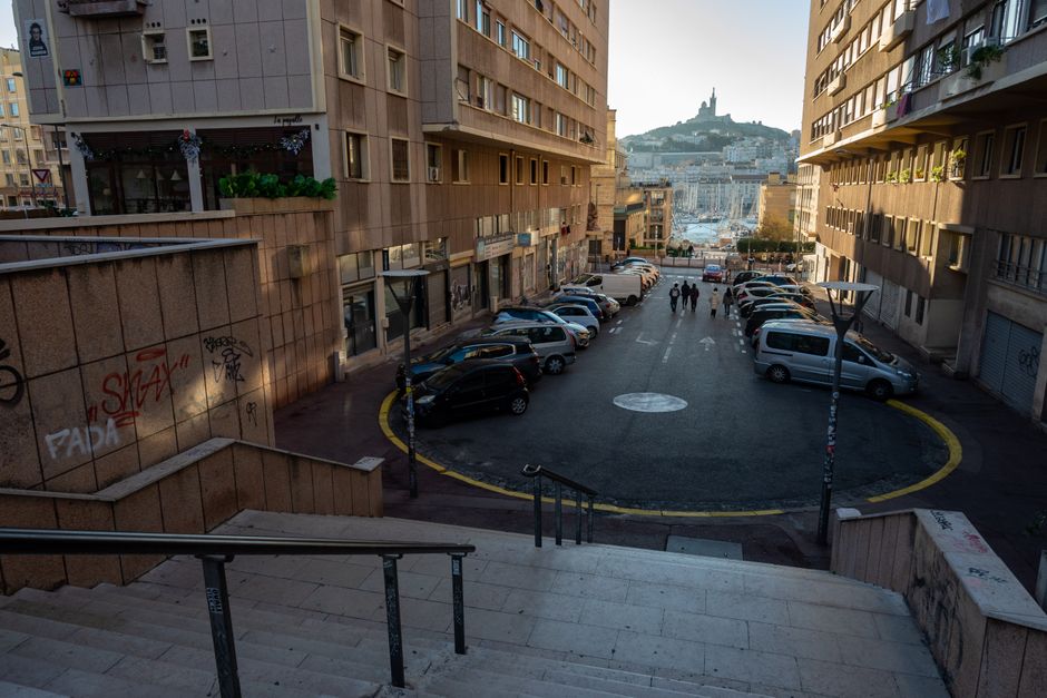 Street scene in Marseille with the Basilica of Notre-Dame de la Garde visible.
