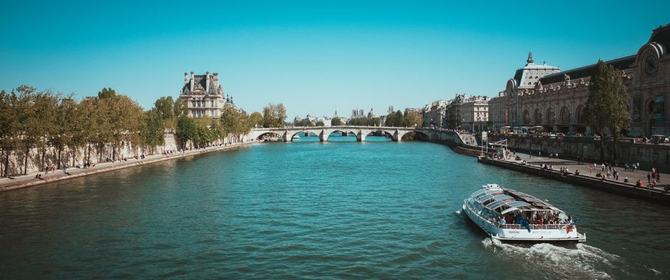 Scenic Paris view of a river cruise on the Seine with historic architecture.