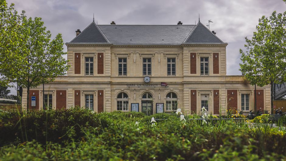 Clisson train station in France, showcasing classic architecture amidst scenic spring foliage.