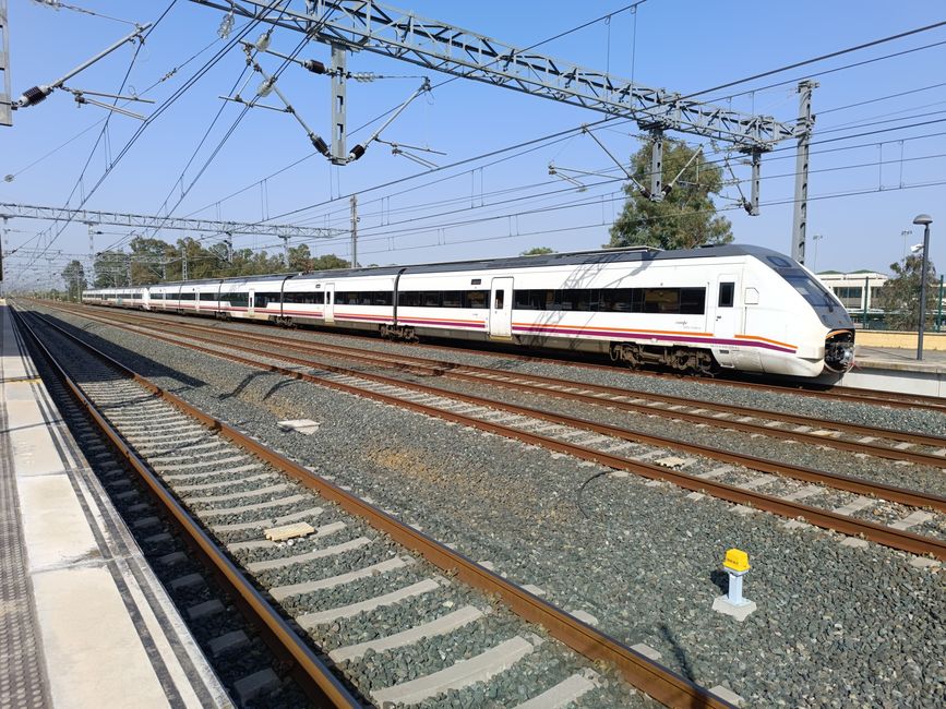 High-speed train at Jerez de la Frontera railway station, sunny day.