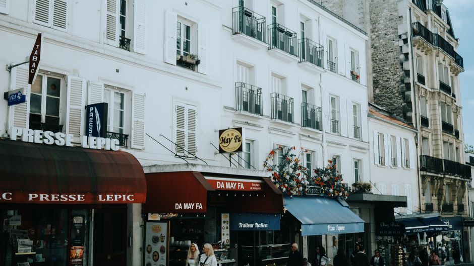 A vibrant street in Montmartre, Paris featuring cafes and traditional architecture, capturing the essence of Parisian life.