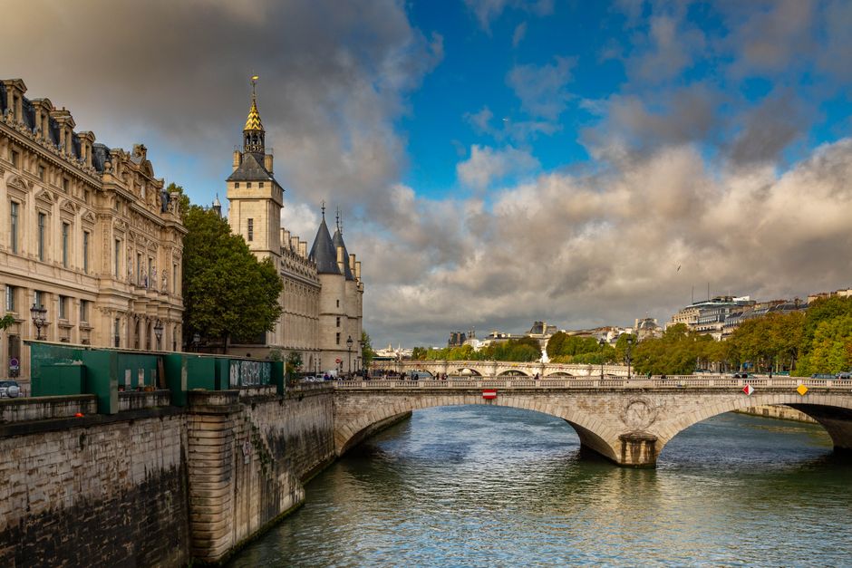 Dramatic sky over the historic Pont au Change in Paris, Seine River view.