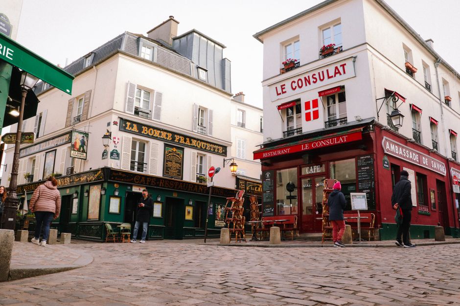 Charming street view of iconic Montmartre cafes in Paris, France.