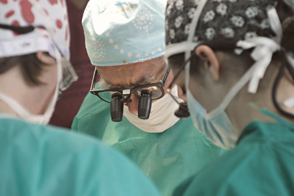 Focused surgical team in an operating room performing a procedure.