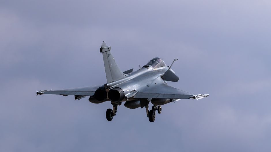 Dassault Rafale jet soaring through cloudy skies, captured outdoors in Los Llanos, Spain.