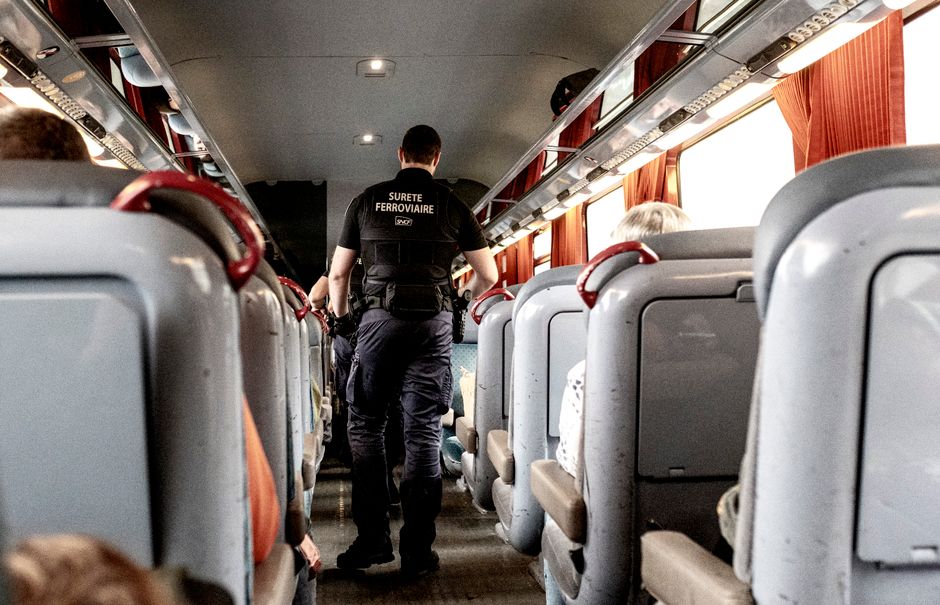 A security officer on a train in France ensures passenger safety during travel.