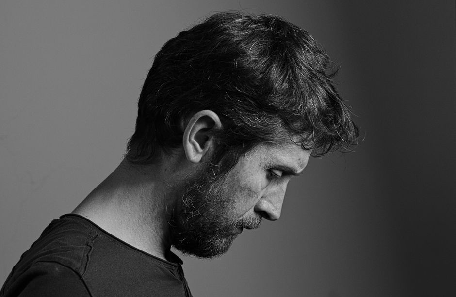 Monochrome side profile portrait of a contemplative man with a beard in France.