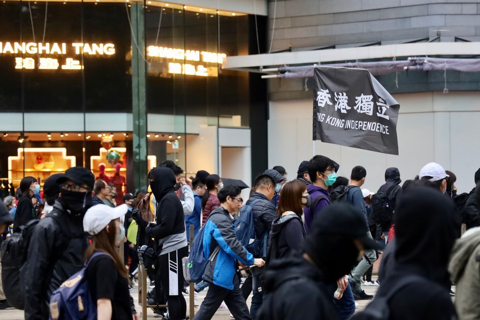 Protestors in Hong Kong advocating for independence with signs.