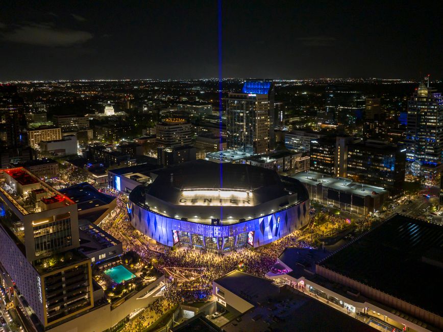 Aerial view of Golden 1 Center illuminated at night in downtown Sacramento, California.