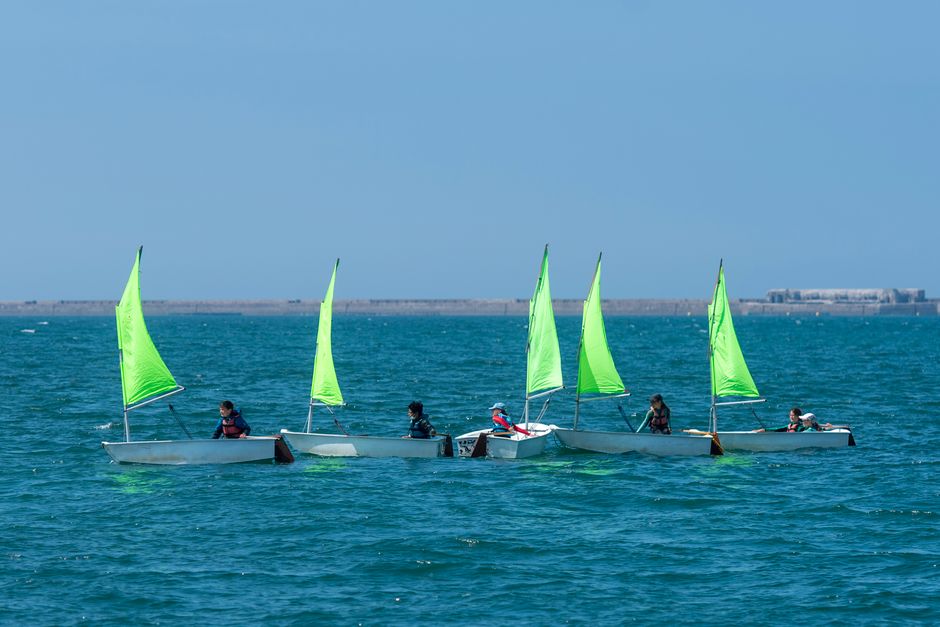 Children learning to sail in Cherbourg-en-Cotentin, France on a sunny day.