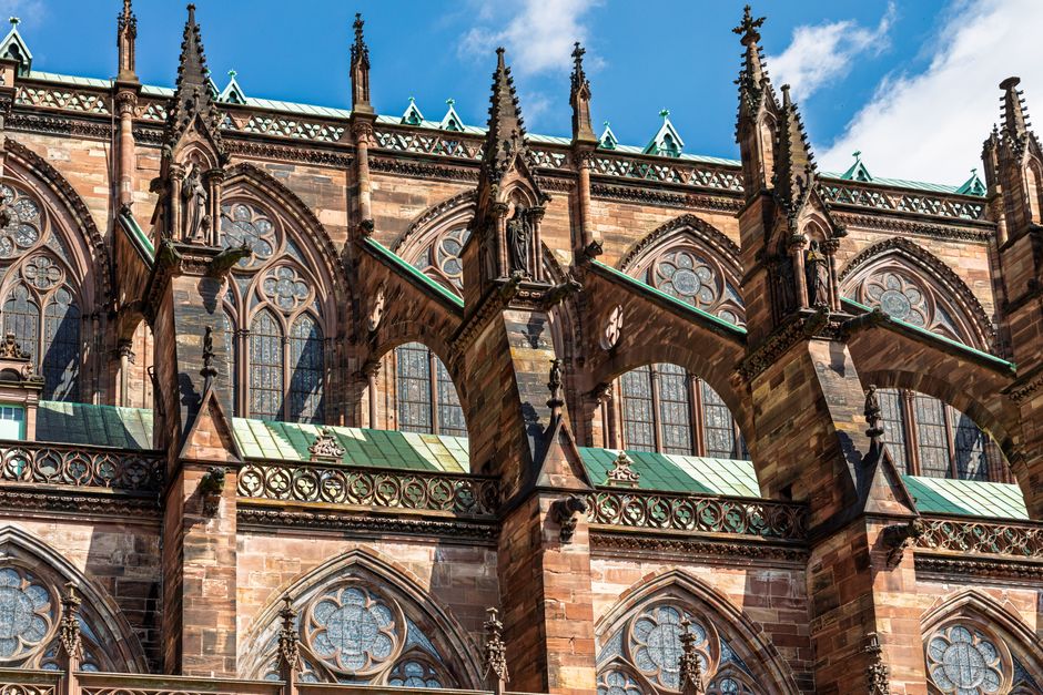 Detailed view of Strasbourg Cathedral's Gothic architecture under a clear blue sky.