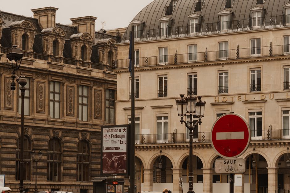 Capture of classic Parisian architecture with a moody sky and street details.