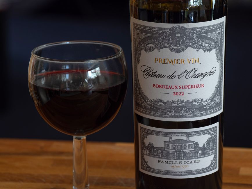 Premier Vin Bordeaux wine bottle and glass, Château de l'Orangerie 2022 label.